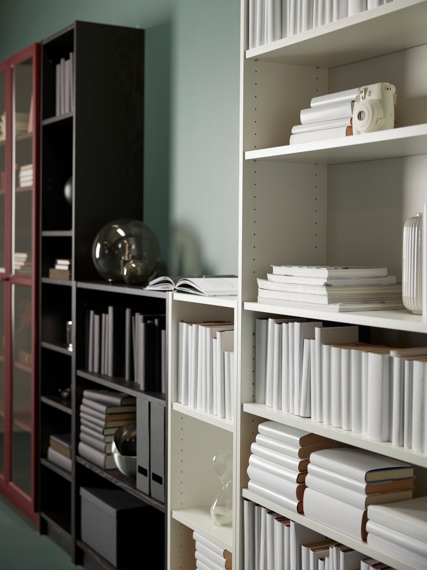 A dark red BILLY bookcase with glass-doors