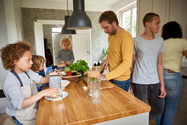 A family spending time in the kitchen.