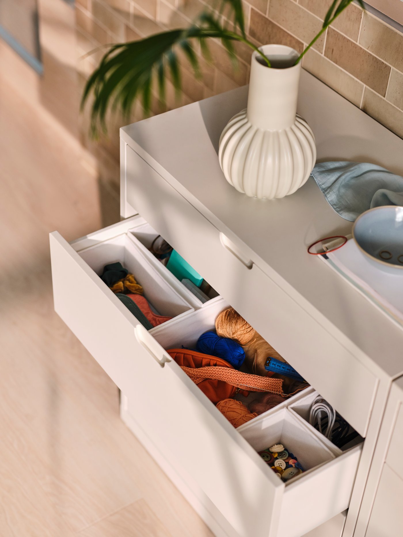 A white SKUBB box in the bedroom