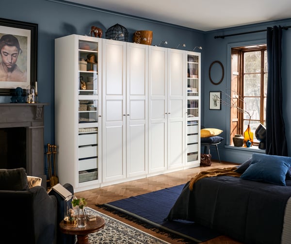 a white PAX closet with TYSSEDAL doors