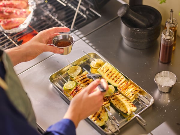A stainless steel GRILLTIDER serving tray