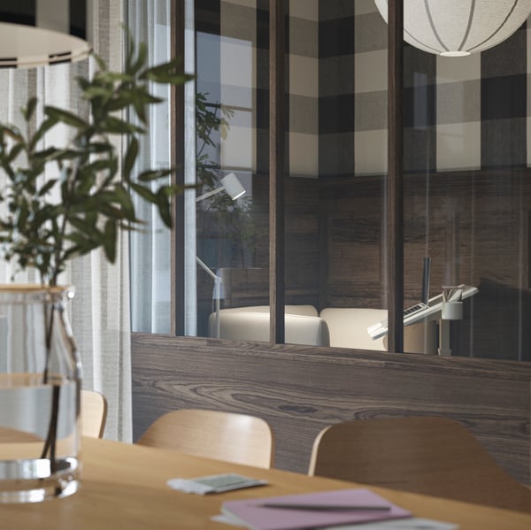 An upgraded office with a chat box, featuring a white MITTZON laptop table and a beige LILLEHEM armchair.