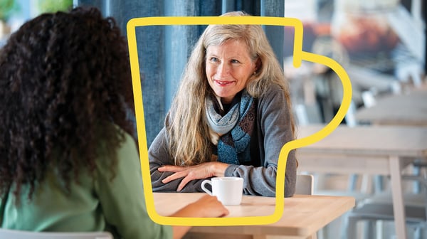 Woman smiling at another woman, having a hot drink in an IKEA store