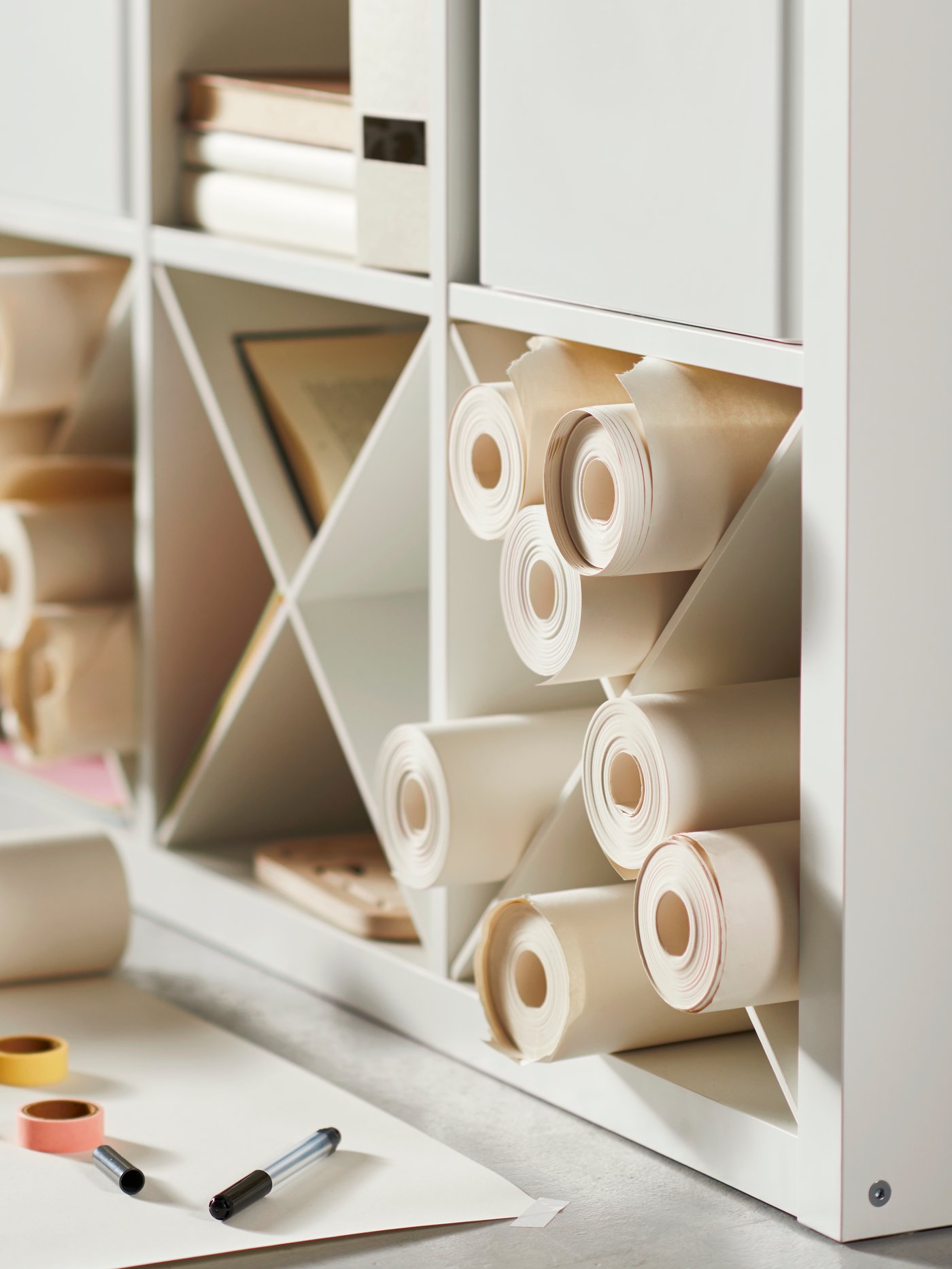 White KALLAX unit with inserts to organizer paper rolls