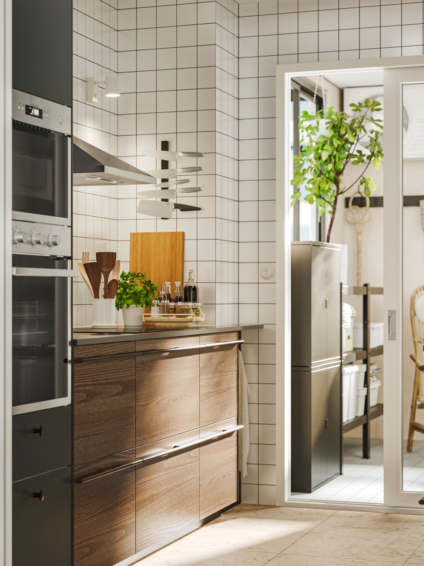 Kitchen with STENSTA dark brown ash veneer fronts, white tiled backsplash, and a view into a pantry with plants and a chair.