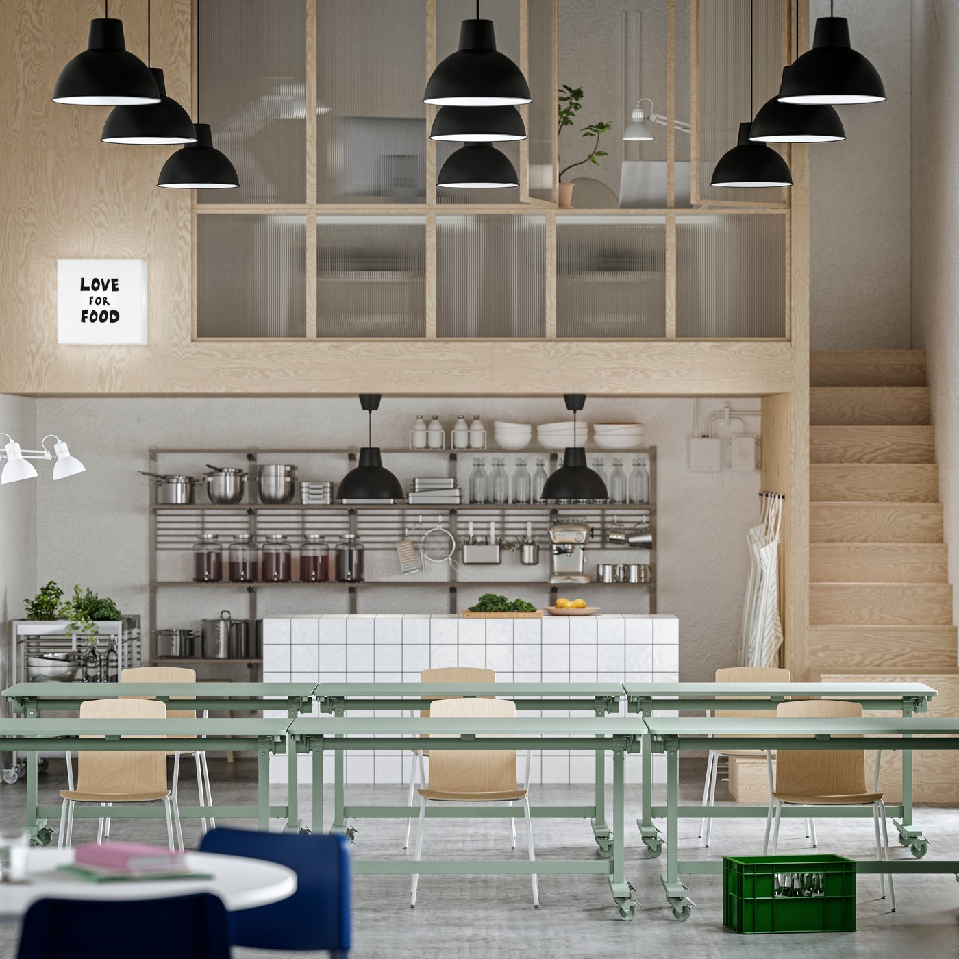 A workspace with event furniture, including green MITTZON foldable tables, LÄKTARE conference chairs, and open shelving.