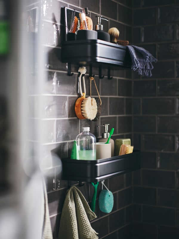 Two LILLASJÖN wall shelves with 5 hooks on a wall holding EKOLN soap dispensers and toothbrush holders and other products.