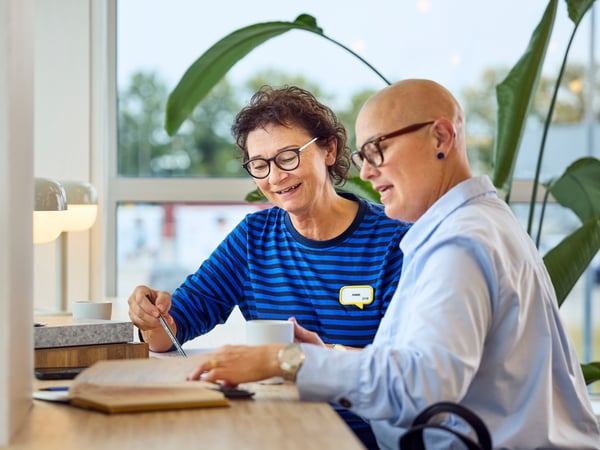 An IKEA interior designer is helping a business client plan a design project.