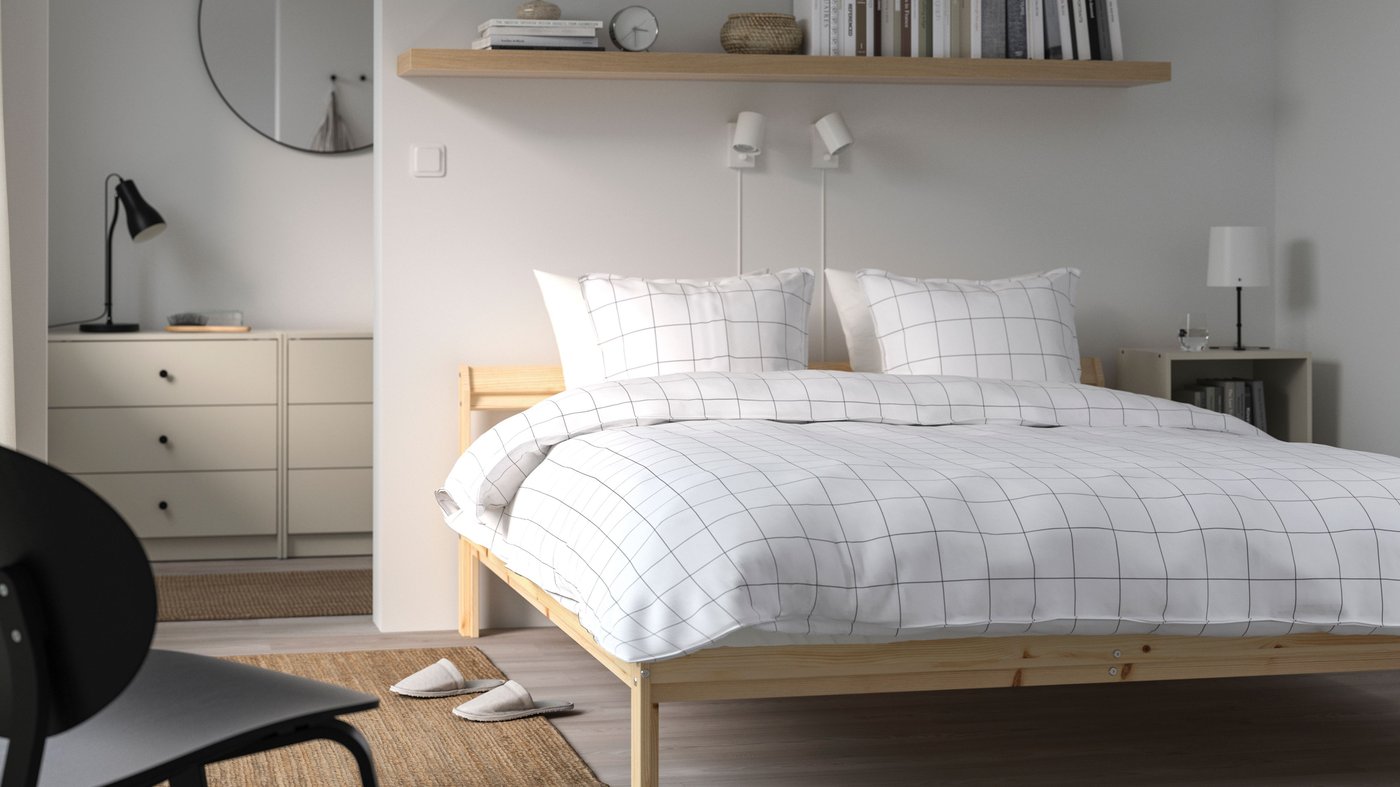 A pine NEIDEN bed frame in the bedroom