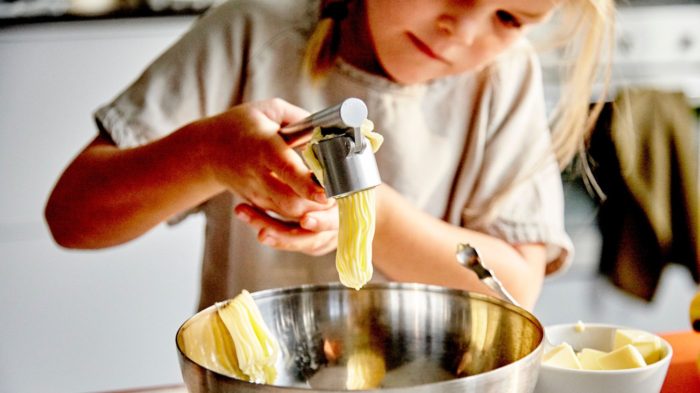 A stainless steel KONCIS garlic press