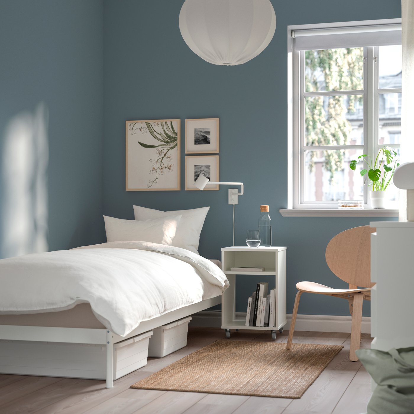 A white VEVELSTAD bed frame in the bedroom