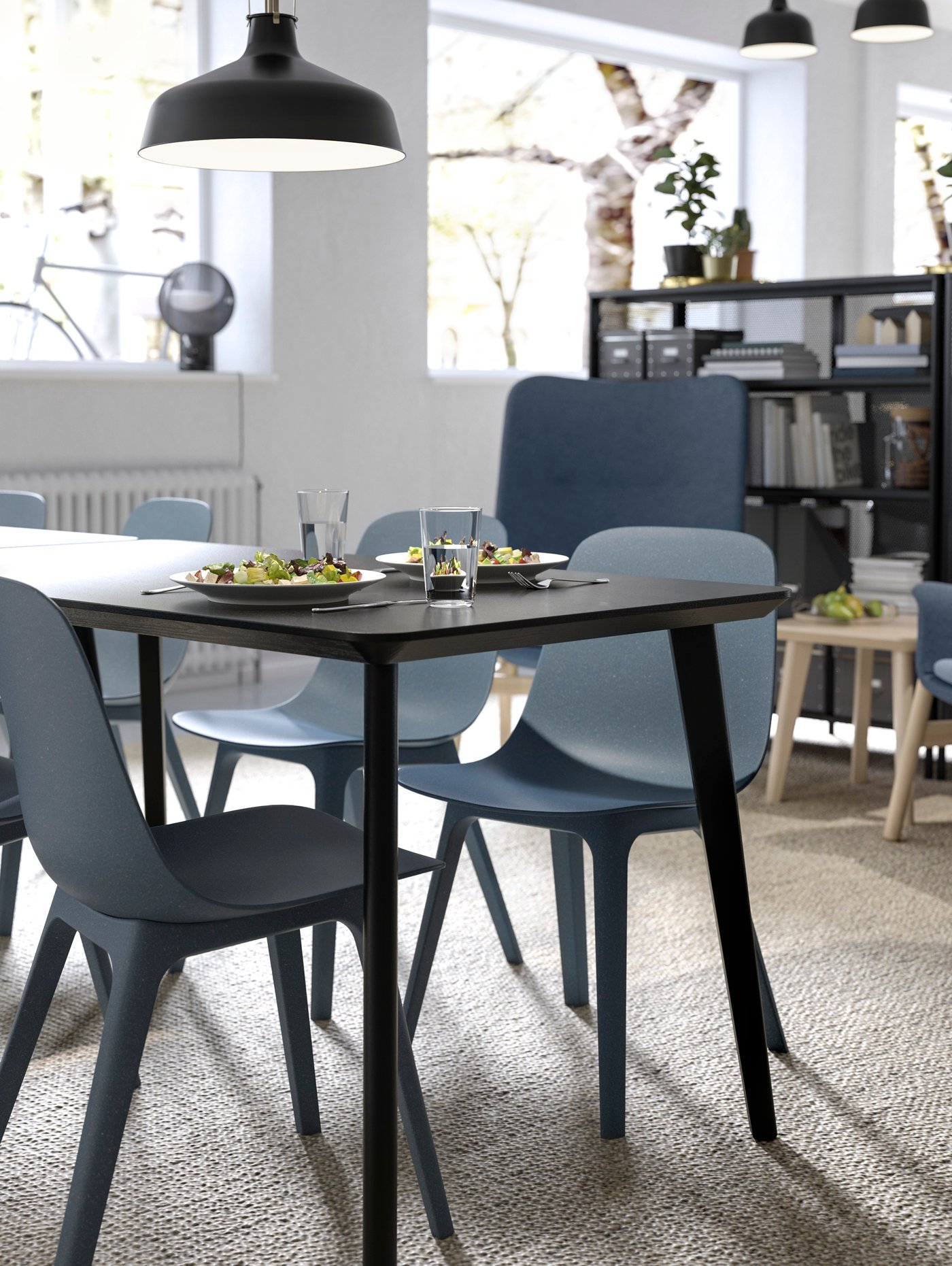 ODGER bowl-shaped chairs and LISABO black rectangular dining table in an open break eating area.