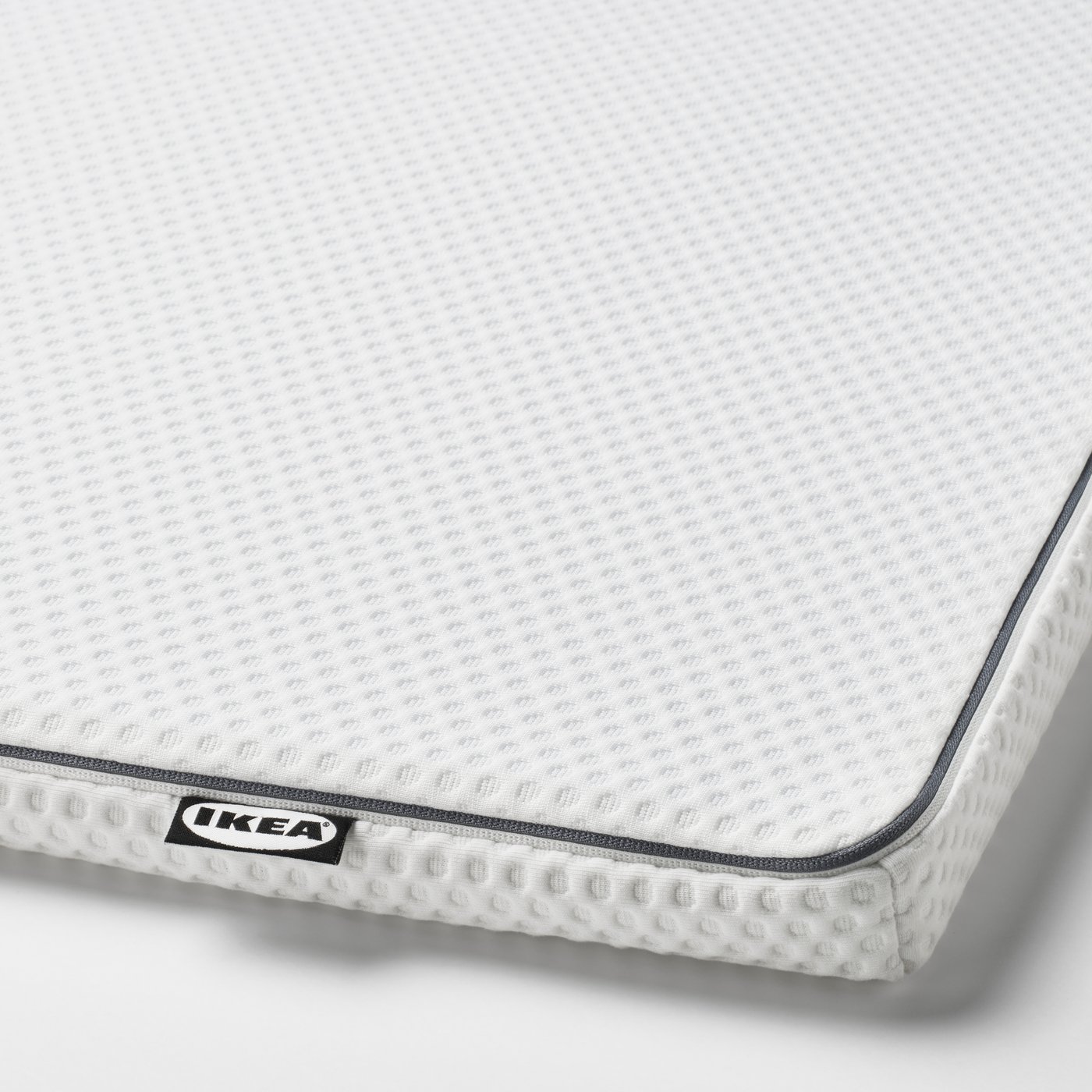 A white NÄSTABERG mattress pad