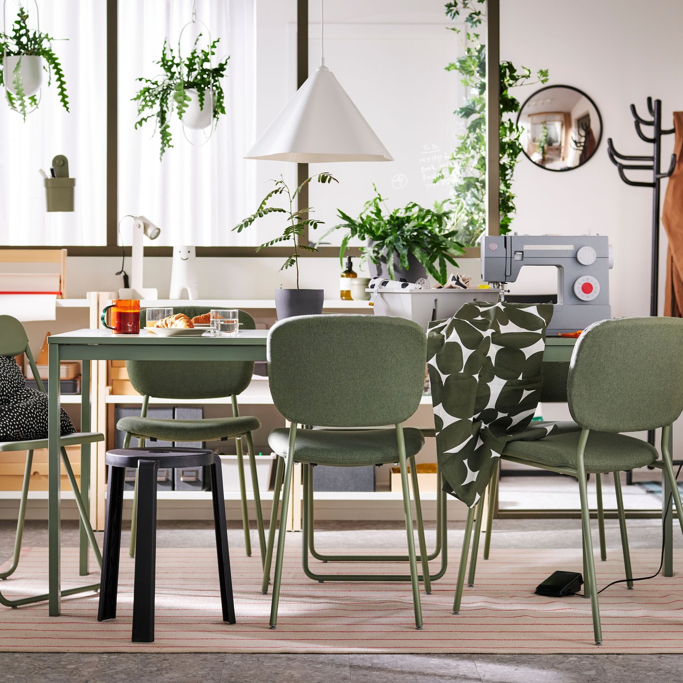 VIHALS chairs and a stool stand at a green VIHALS extendable table on a rug in a multifunctional dining room.