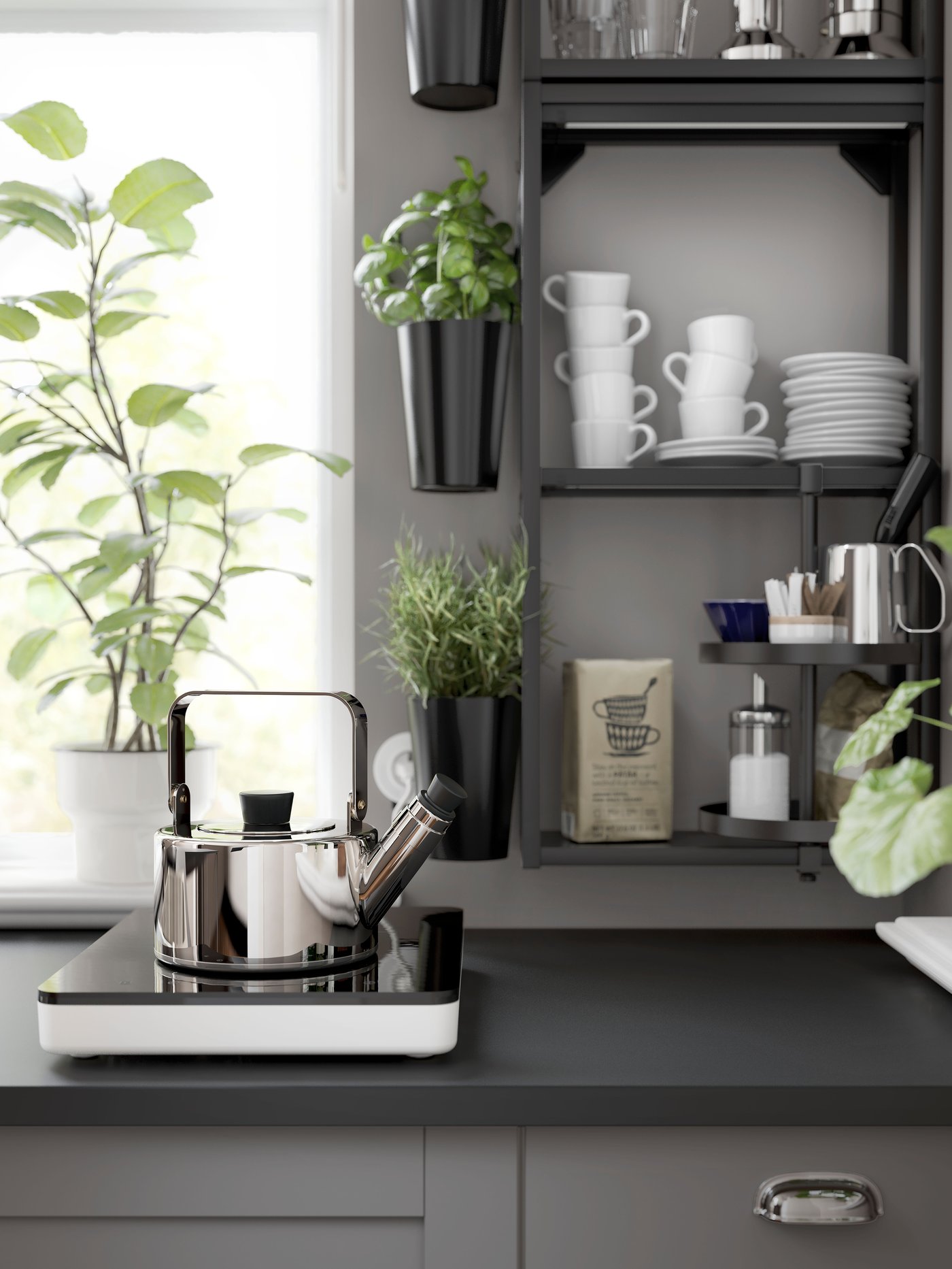 A METALLISK kettle on top of a TILLREDA induction cooktop.