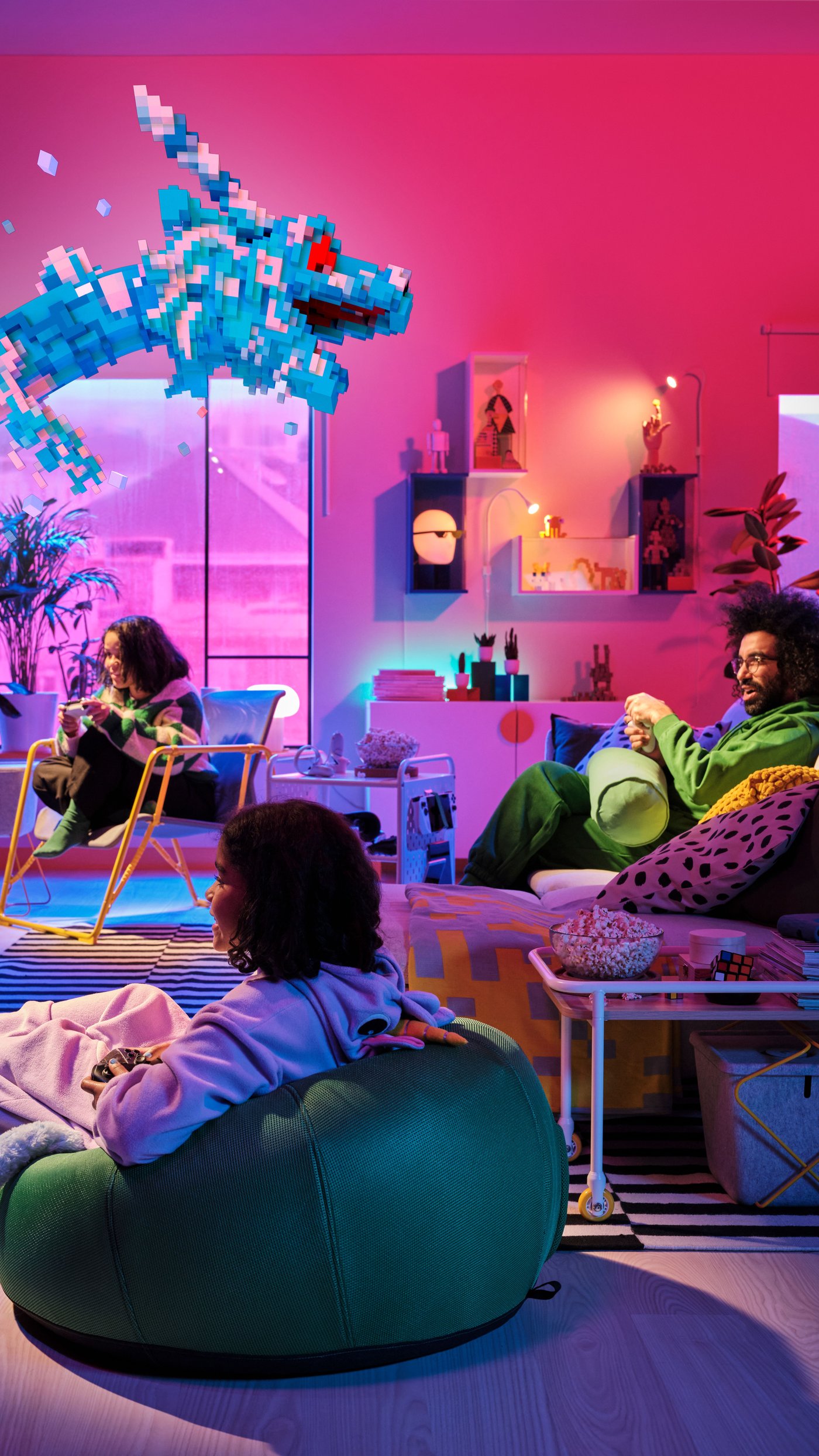 Three people are playing video games with the BRÄNNBOLL game collection.