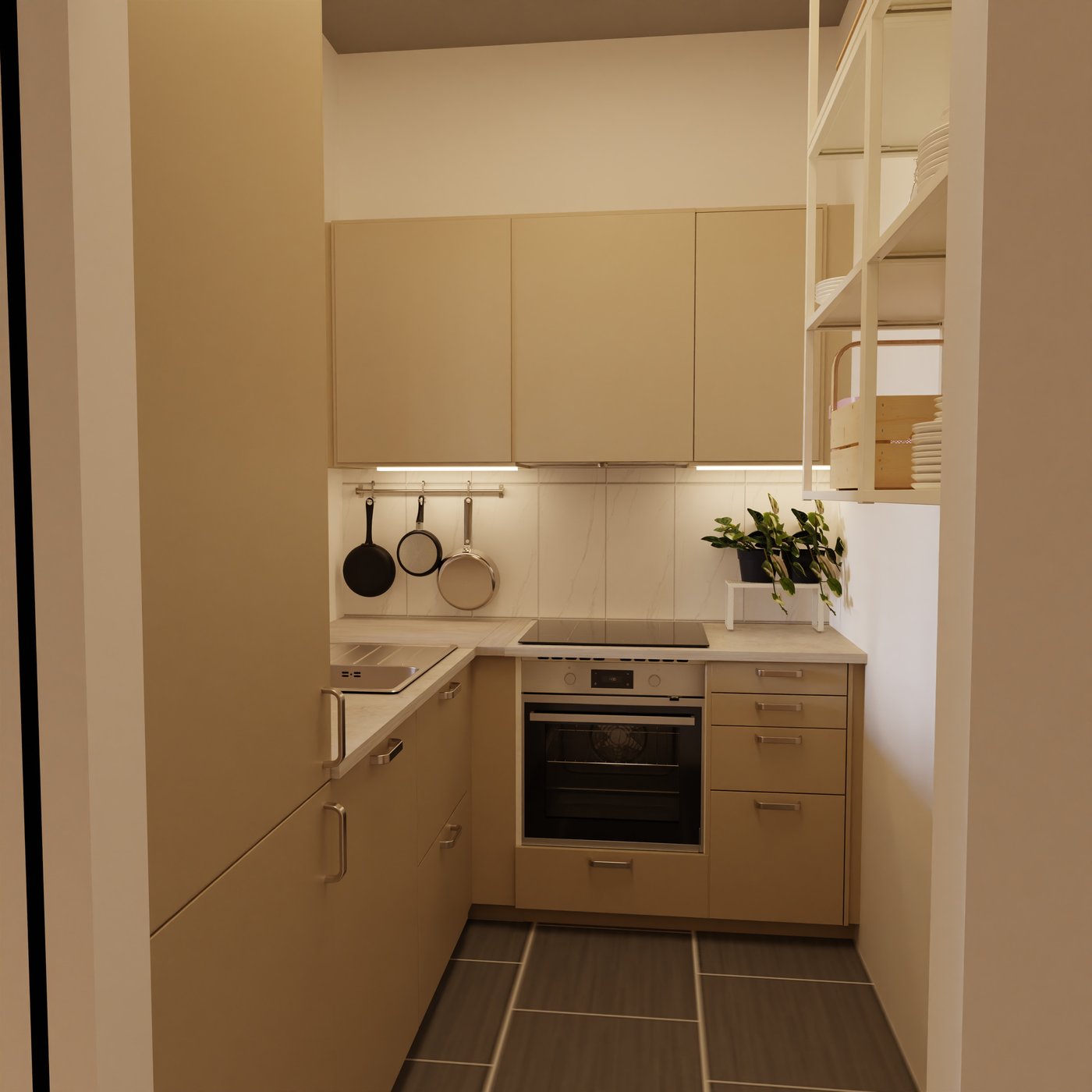 Blick in die L- Küche mit dem Backofen an der kurzen Seite, darüber sind wandschränke.