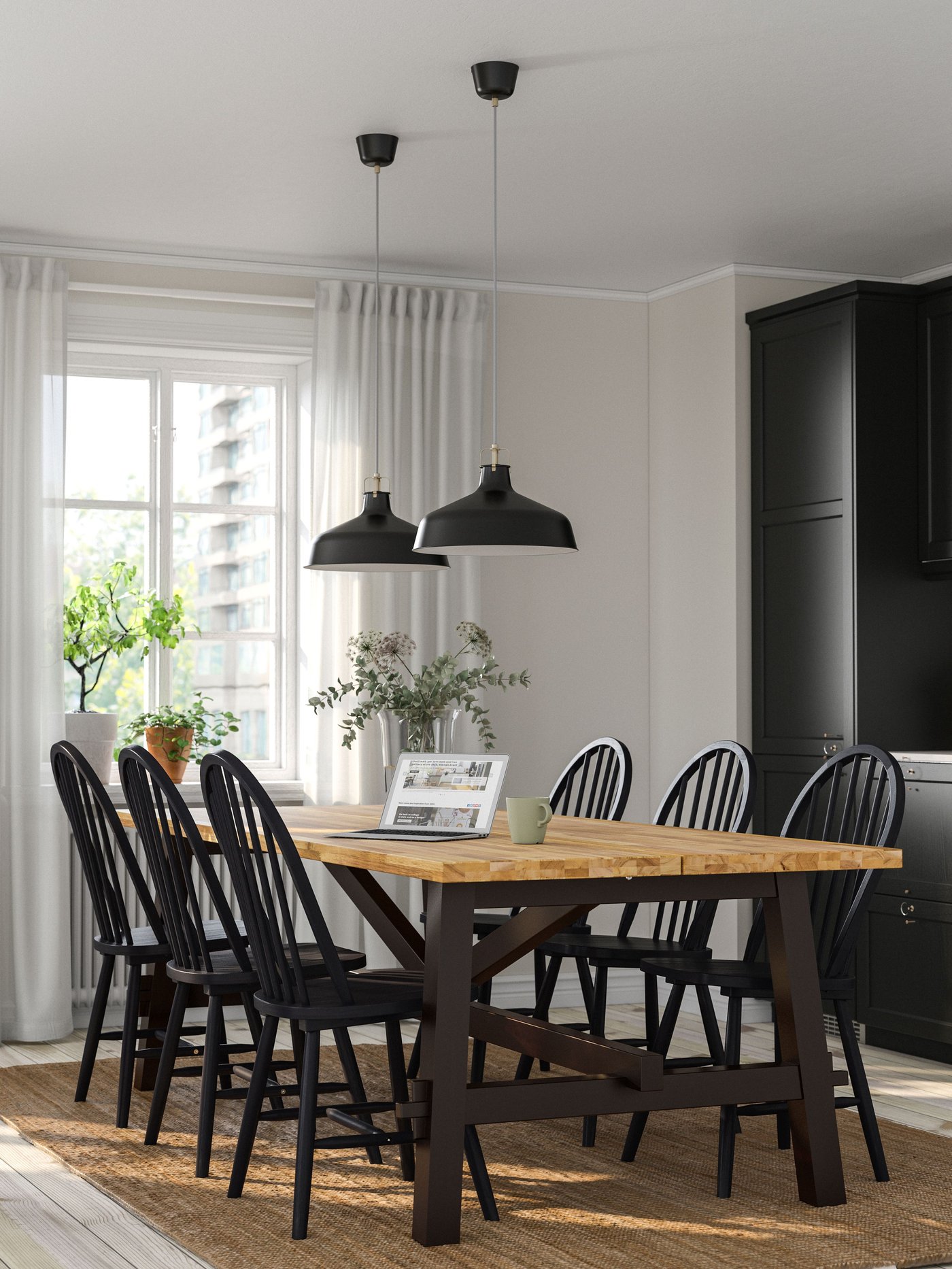 An acacia/black SKOGSTA dining table