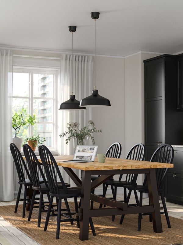 An acacia/black SKOGSTA dining table in the kitchen