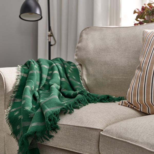 A dark green SVINROT throw