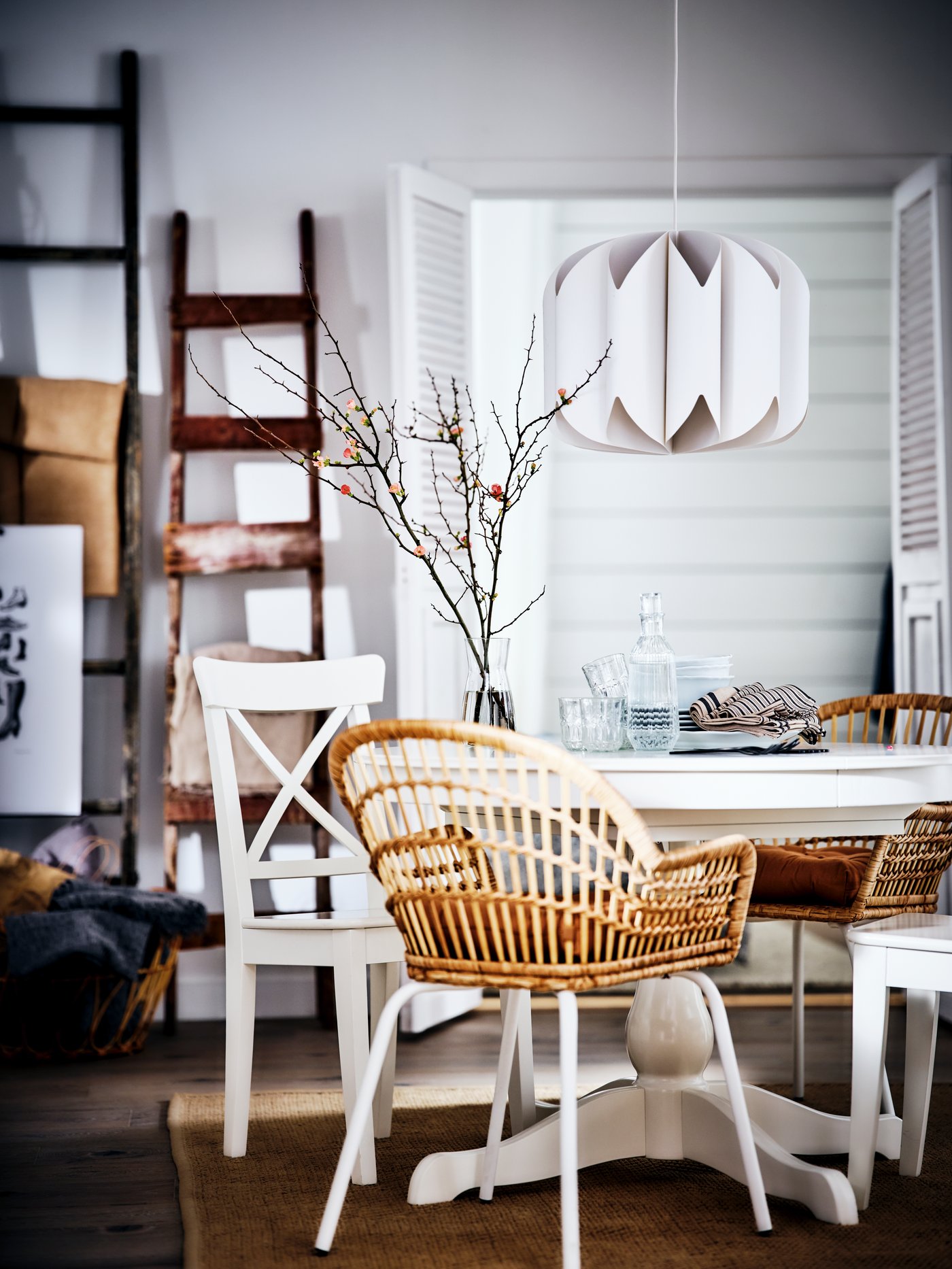 A textile/white MOJNA pendant lampshade in the dining room