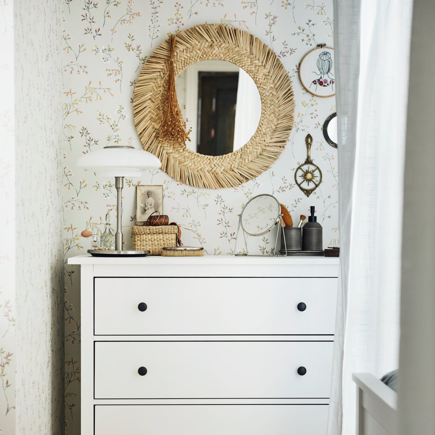 A silver-colour LASSBYN table mirror