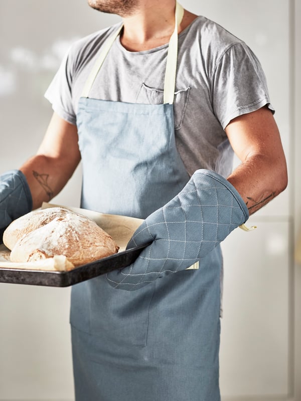 A textile/blue SANDVIVA oven glove