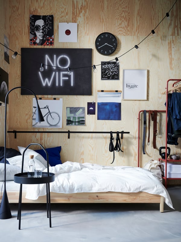 A black DELAKTIG LED floor lamp in the bedroom