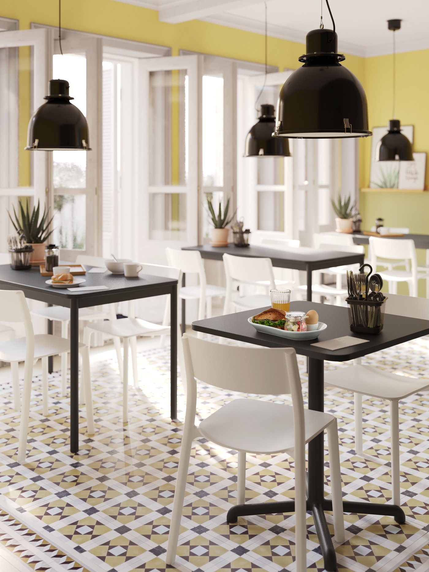 Breakfast served on a STENSELE anthracite table and two TOMMARYD anthracite tables with white chairs.