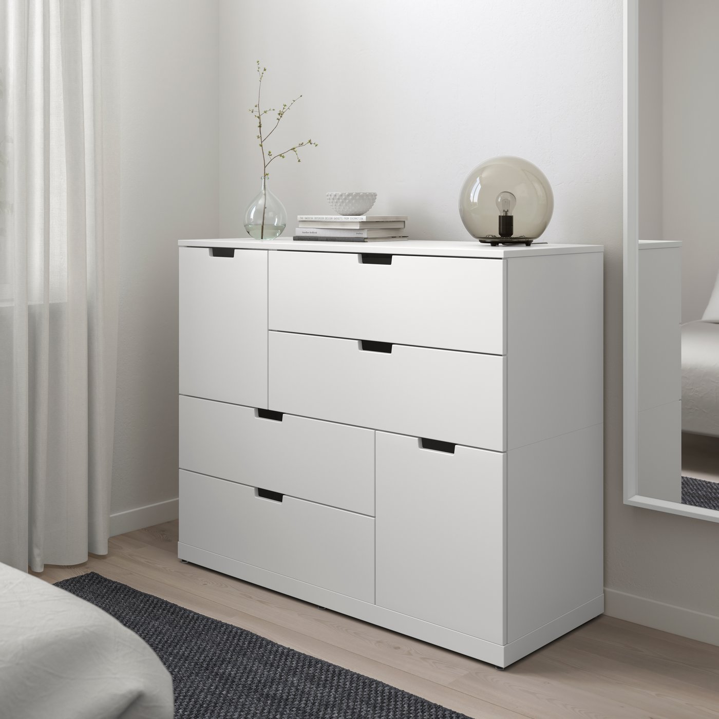 A white NORDLI chest of 6 drawers in the bedroom