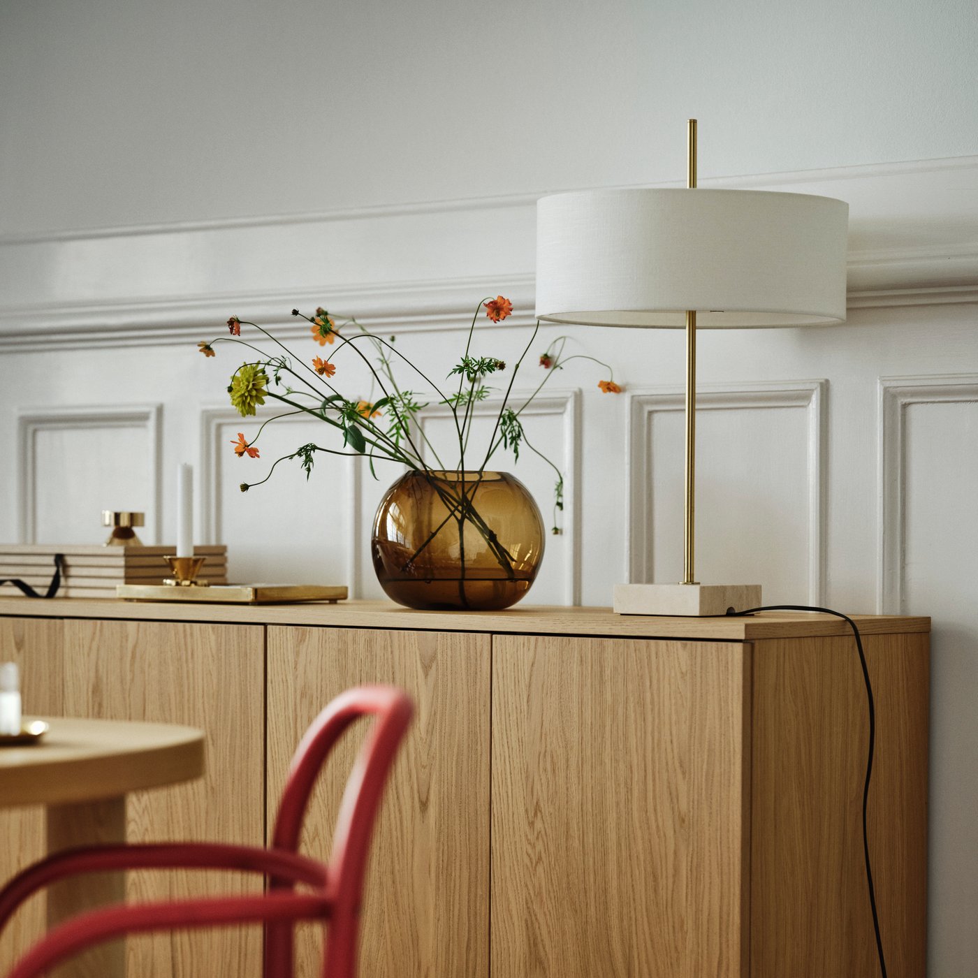 A brass-colour STOCKHOLM 2025 candlestick/tealight holder in the dining room