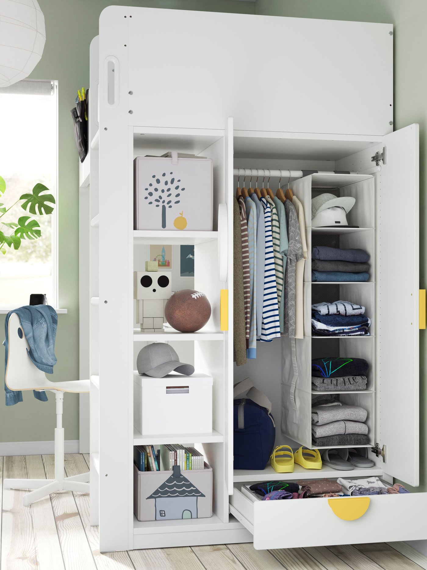 Ein SMASTAD Hochbett in weiß mit integriertem Kleiderschrank. In dem Kleiderschrank sind Boxen, Hängeaufbewahrung und Kleidung untergebracht. 