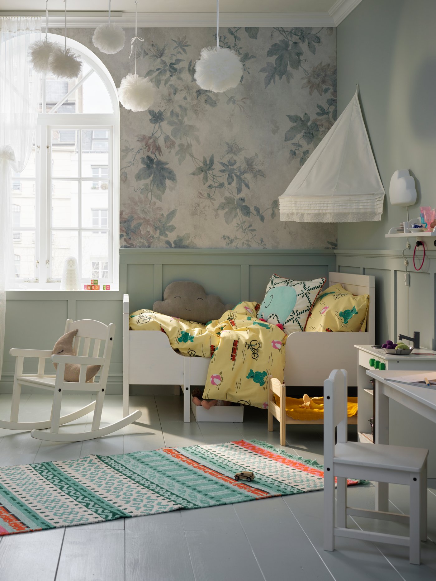 A pine/multicolour DUKTIG doll's bed with bedlinen set in the bedroom