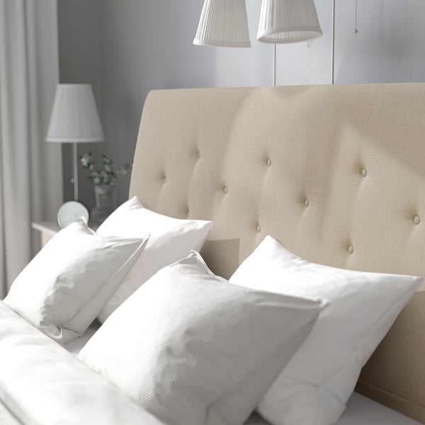 A Naggen beige IDANÄS upholstered bed frame
