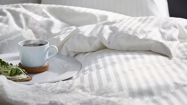 A firm/white ÅKREHAMN foam mattress in the bedroom