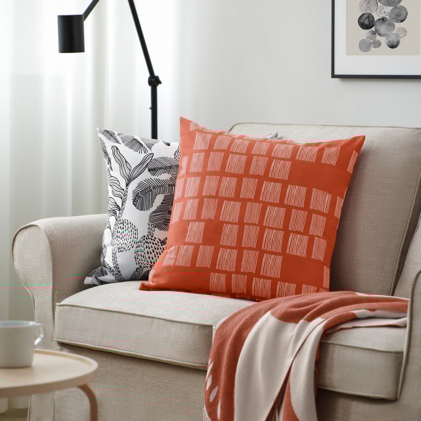 Orange cusion on a beige IKEA couch