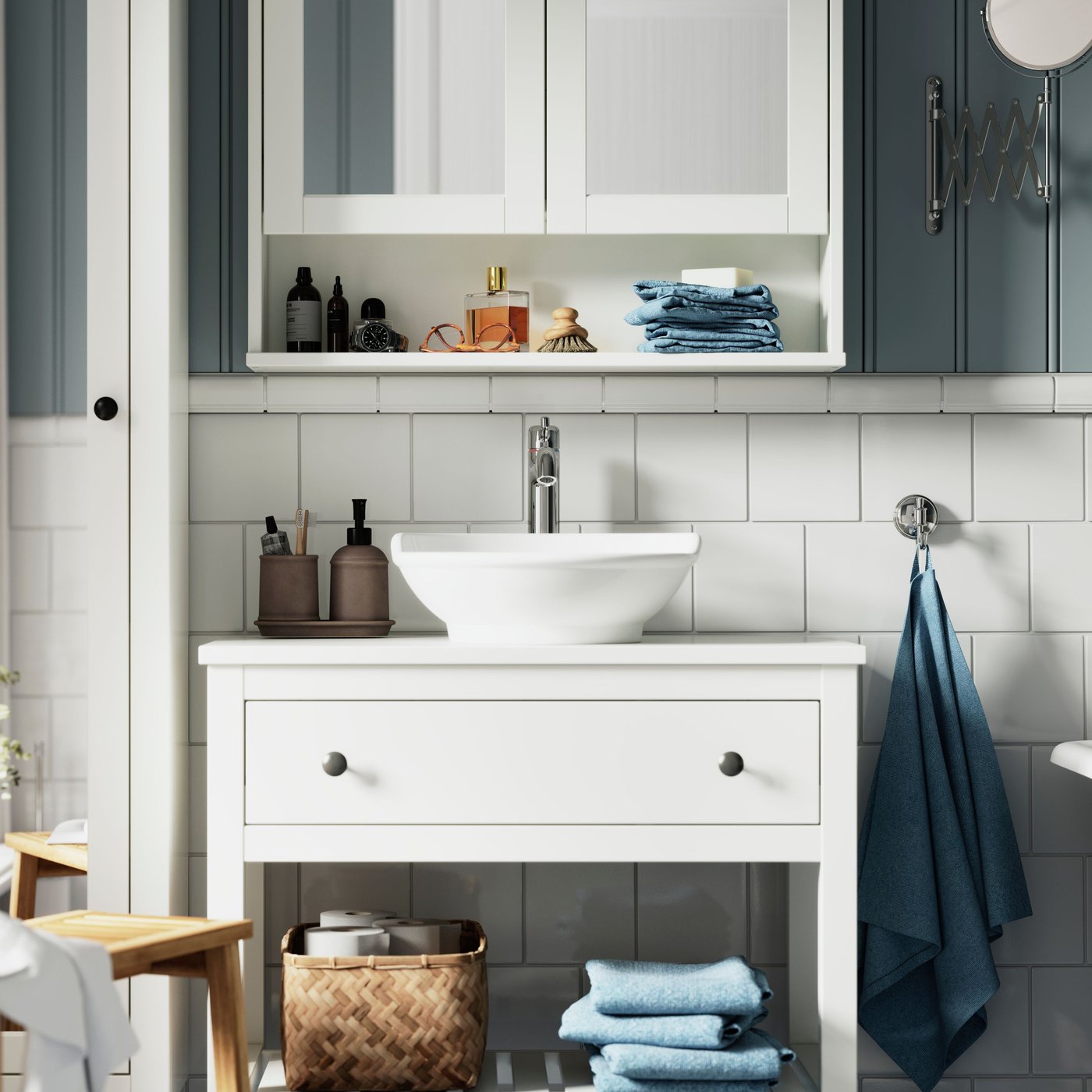 A bright bathroom has a HEMNES wash-stand with a white VÄSTERSJÖN countertop washbasin and a white mirror cabinet above it.