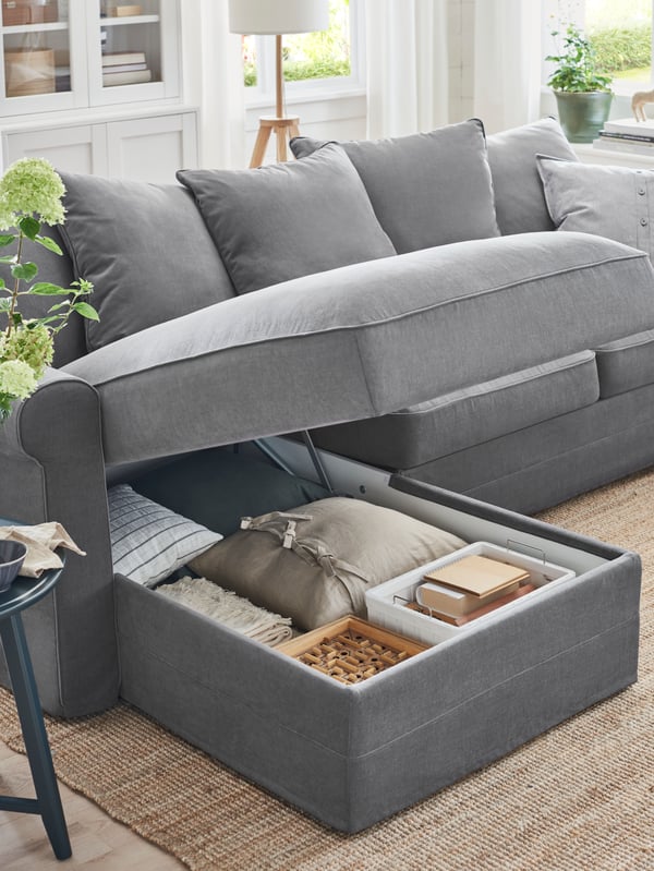 GRÖNLID three-seat sofa with chaise lounge, the top open with hidden storage compartment inside.