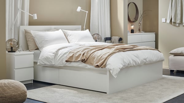 A walnut veneer STOCKHOLM mirror in the bedroom
