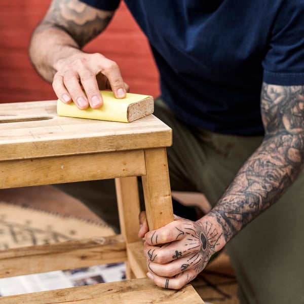A man repairing a stool