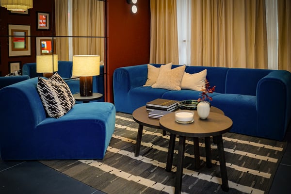 Curious Library room setting at IKEA Tampines, featuring a Alhamn dark turquoise STOCKHOLM 2025 3-seat sofa, STOCKHOLM 2025 Side table, and STOCKHOLM 2025 coffee table.