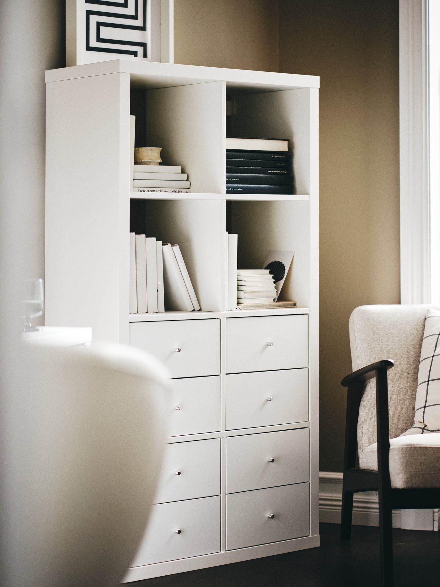 A high-gloss white KALLAX shelving unit
