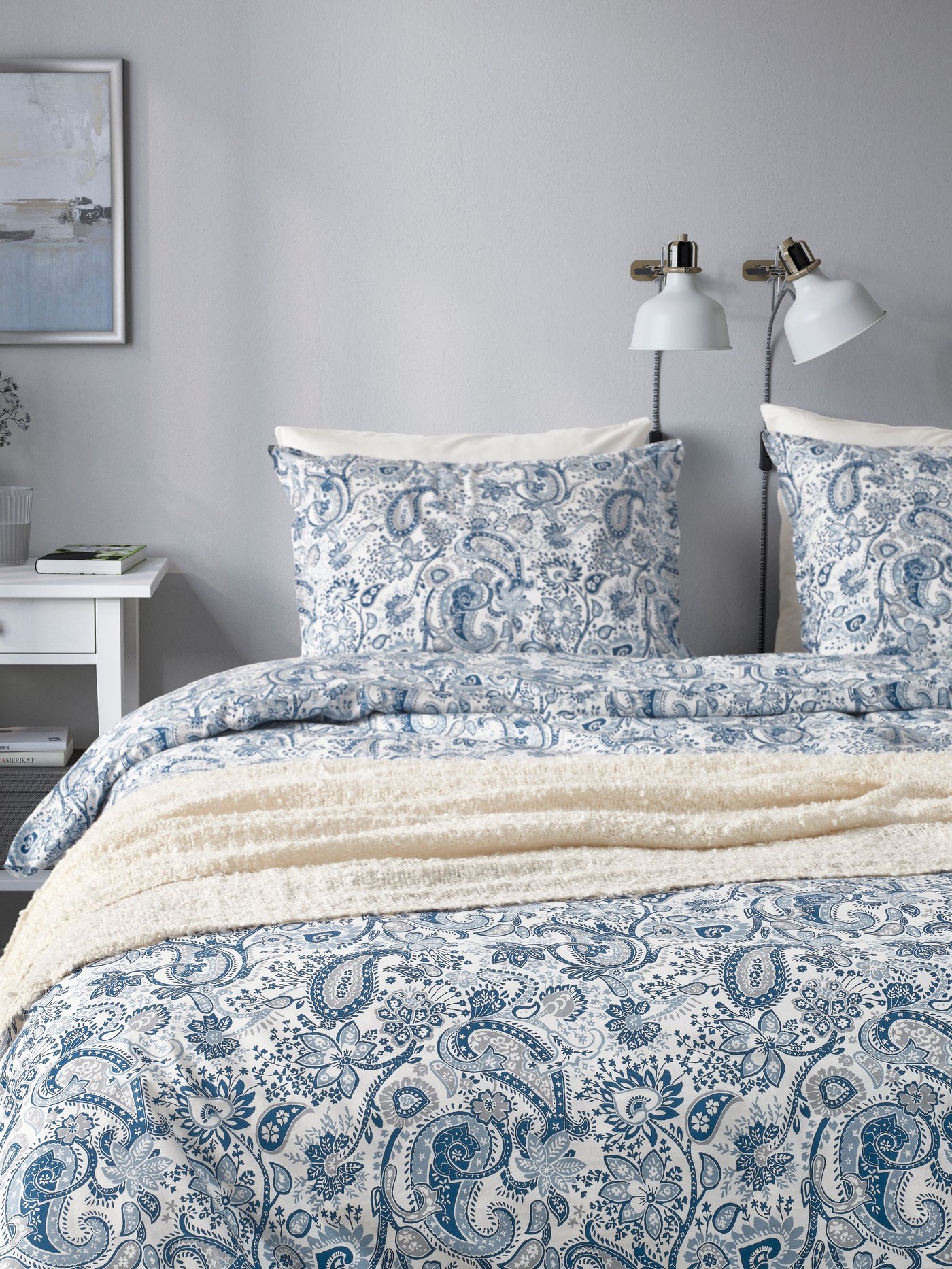 An off-white SANDBRODD throw