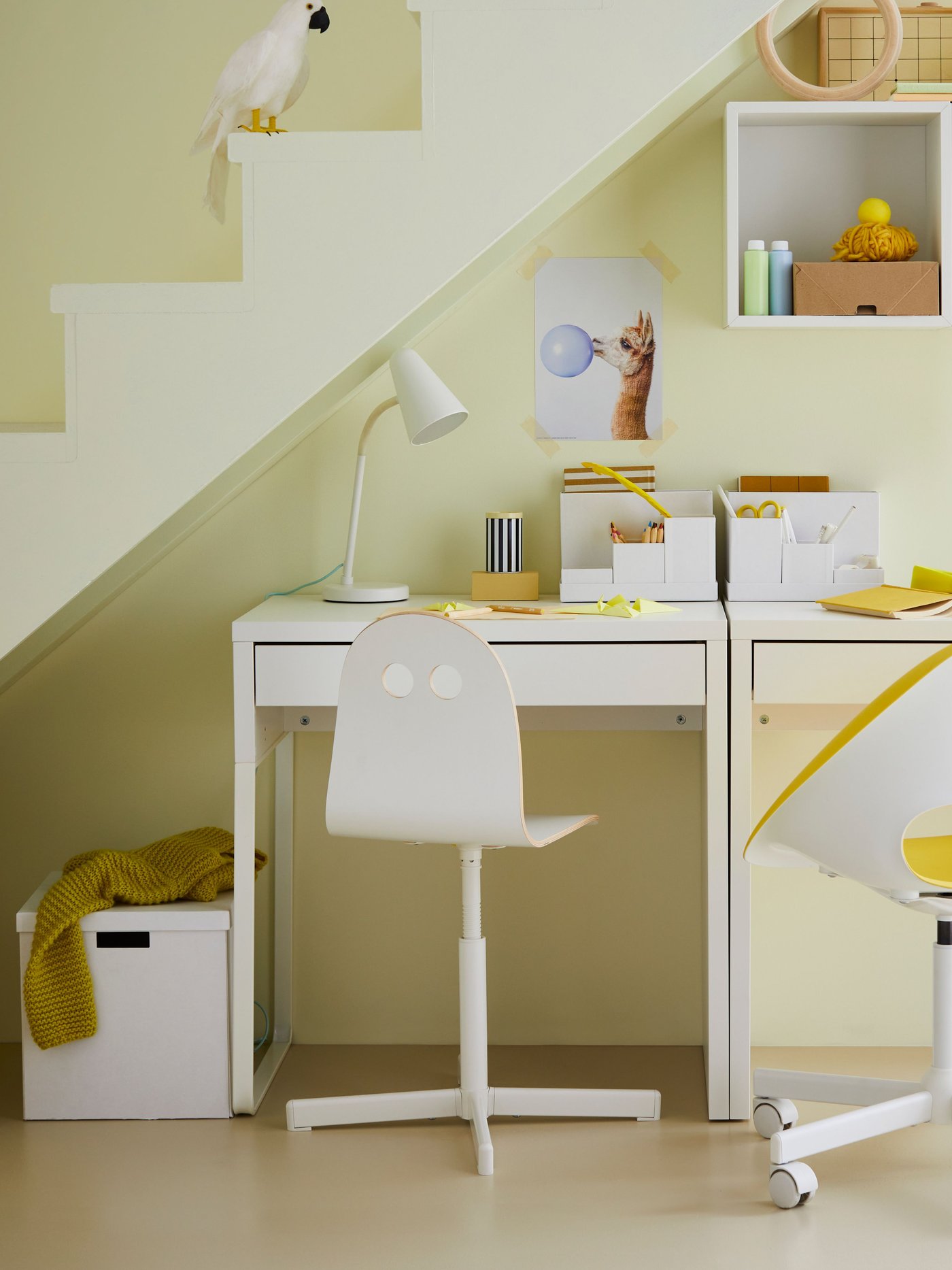A white TJENA storage box with lid