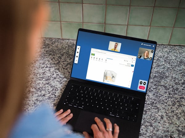 A woman having an online meeting on a laptop.