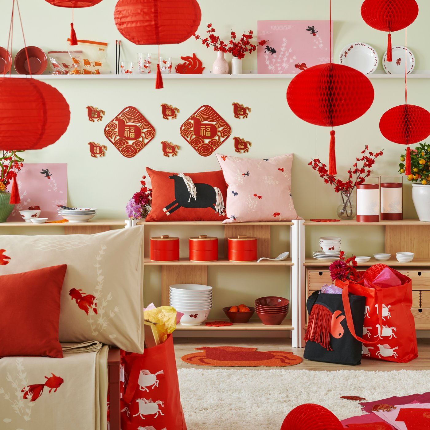 A vibrant room decorated for a celebration features a red FÖSSTA cushion cover on a shelf amidst festive decorations.