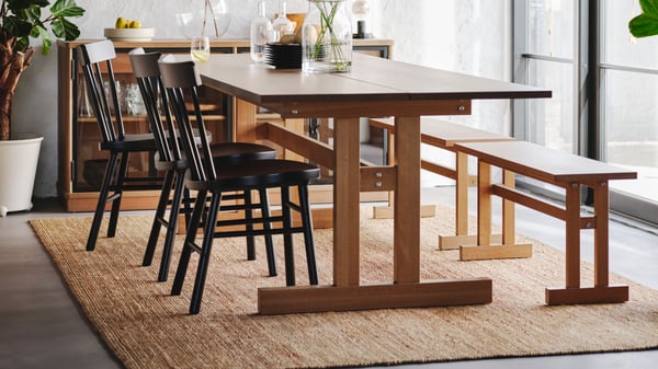 LOHALS rug under a dining table in a bright dining room.