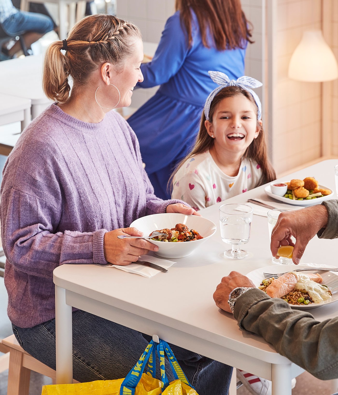 a family of 3 enjoying a meal in the Swedish Restaurant