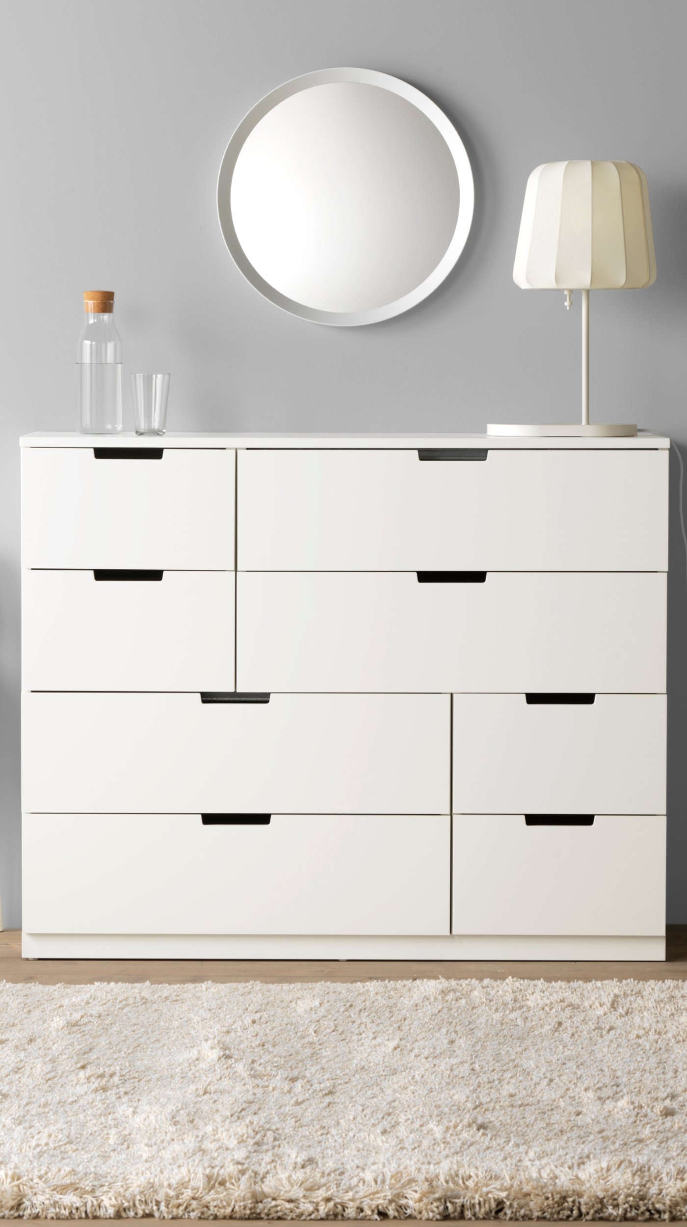 A white LANGESUND mirror in the bedroom