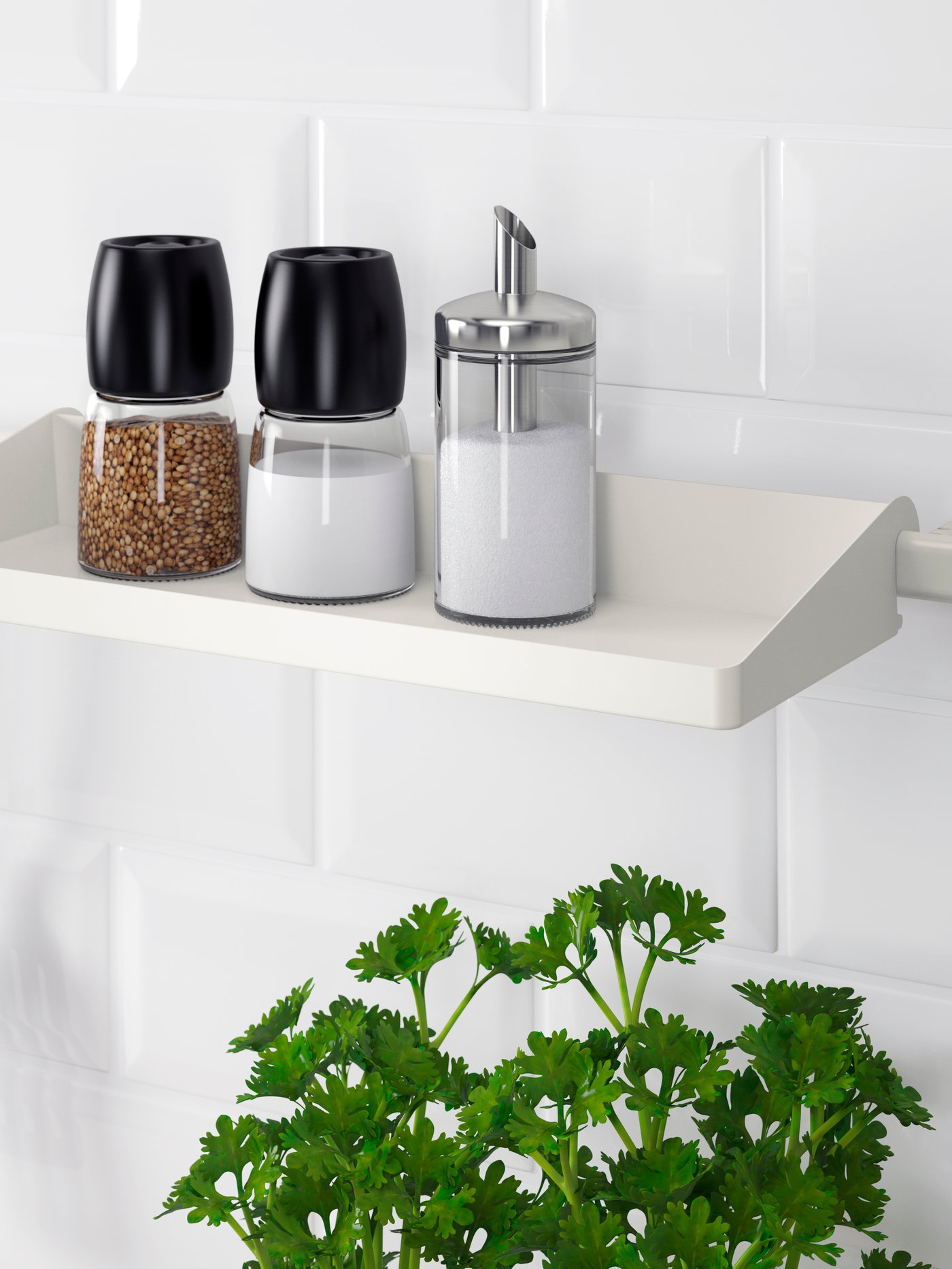Two IKEA 365+ IHÄRDIG spice grinders and a DOLD portion dispenser with sugar on a SUNNERSTA shelf above a flower pot with parsley.